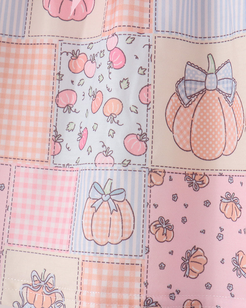 Pink patchwork print fabric with pumpkin motifs and patch square pattern