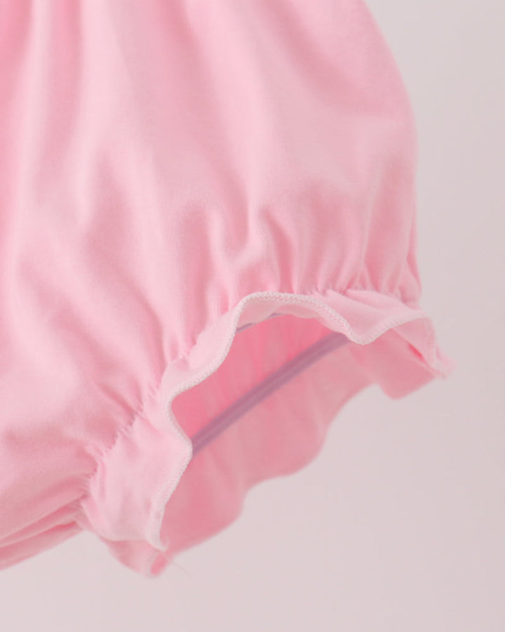 Pink bloomer shorts with elastic leg openings and gathered ruffle hem