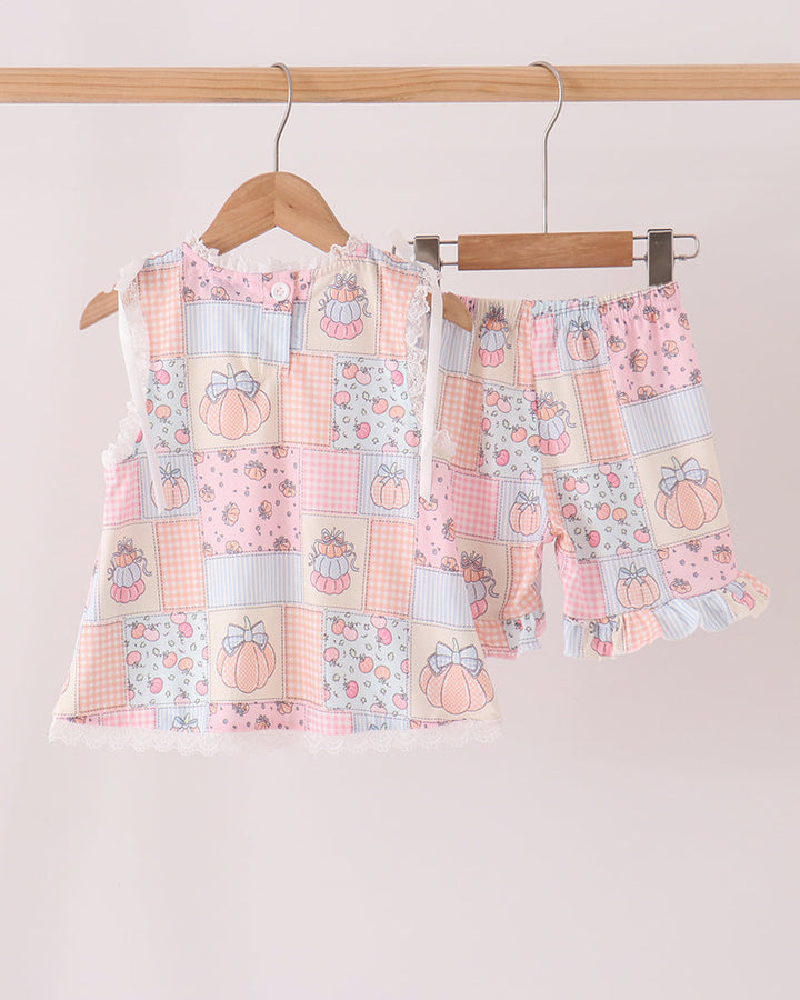 Patchwork ruffle shorts set with sleeveless top and matching shorts, pastel pumpkin motifs