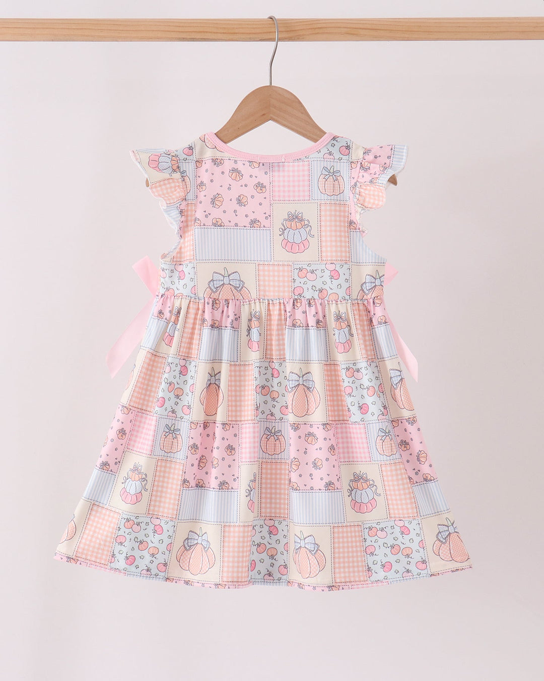 Pink pumpkin print ruffle dress with flutter cap sleeves and full skirt