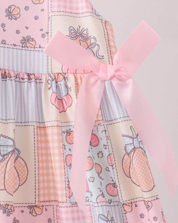 Pink and blue pumpkin patchwork dress with bow-tied sash detail