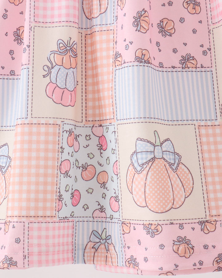 Pumpkin and bow patchwork pattern on pink ruffle dress fabric