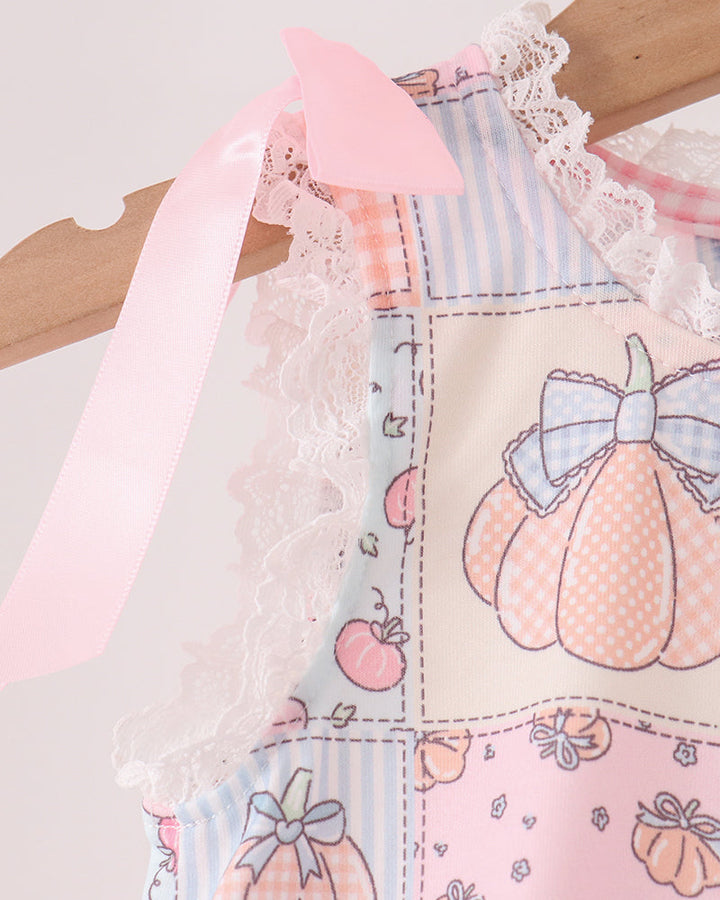 White lace-trim neckline and pink ribbon ties on pumpkin print romper