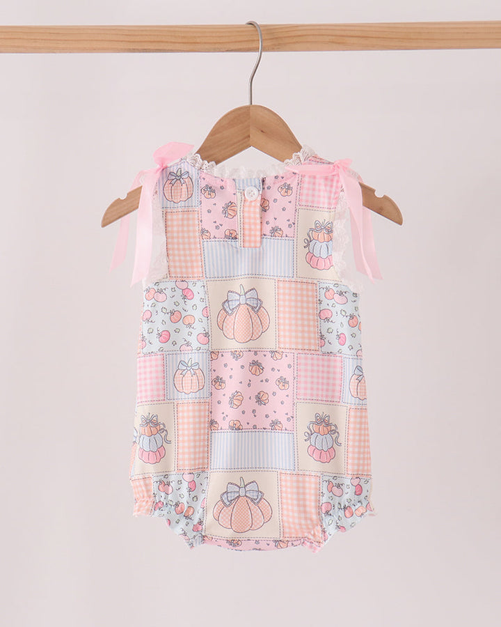 Pink pumpkin print bubble romper with ruffled sleeves and ribbon bows