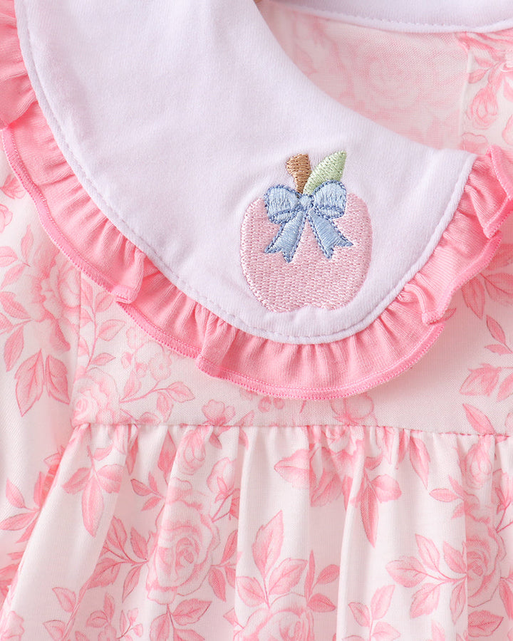White scalloped collar with embroidered apple patch on pink ruffle neckline