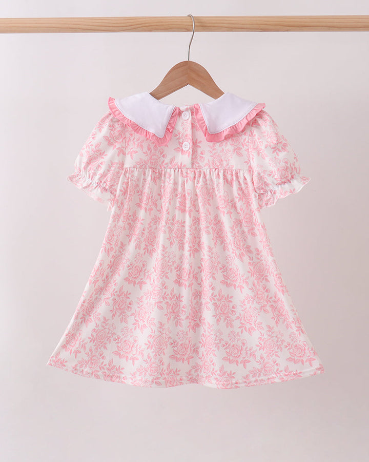 Pink floral dress with white collar, button front, and tiered skirt ruffles
