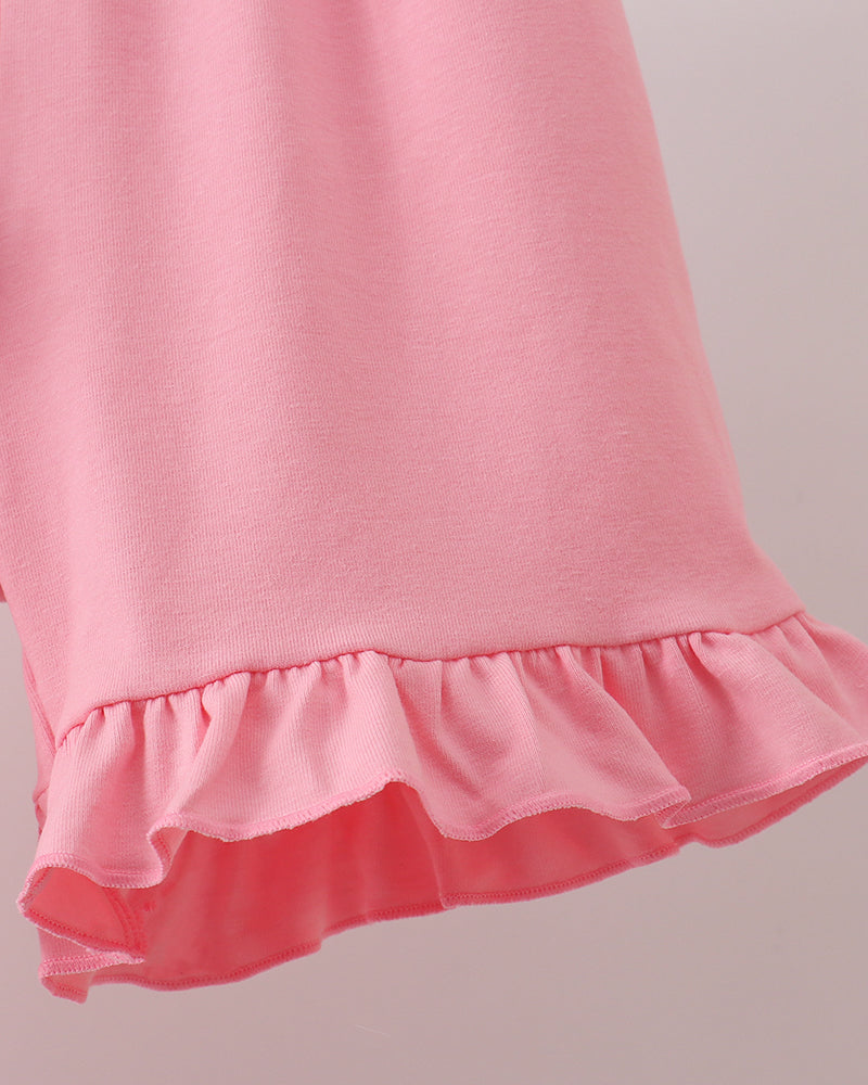 Pink ruffle hemline on dress skirt with layered ruffle trim