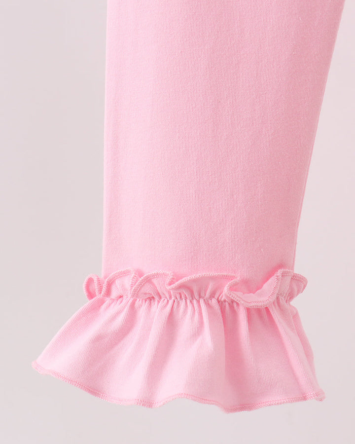 Pink leggings with gathered ruffle cuffs at the ankle