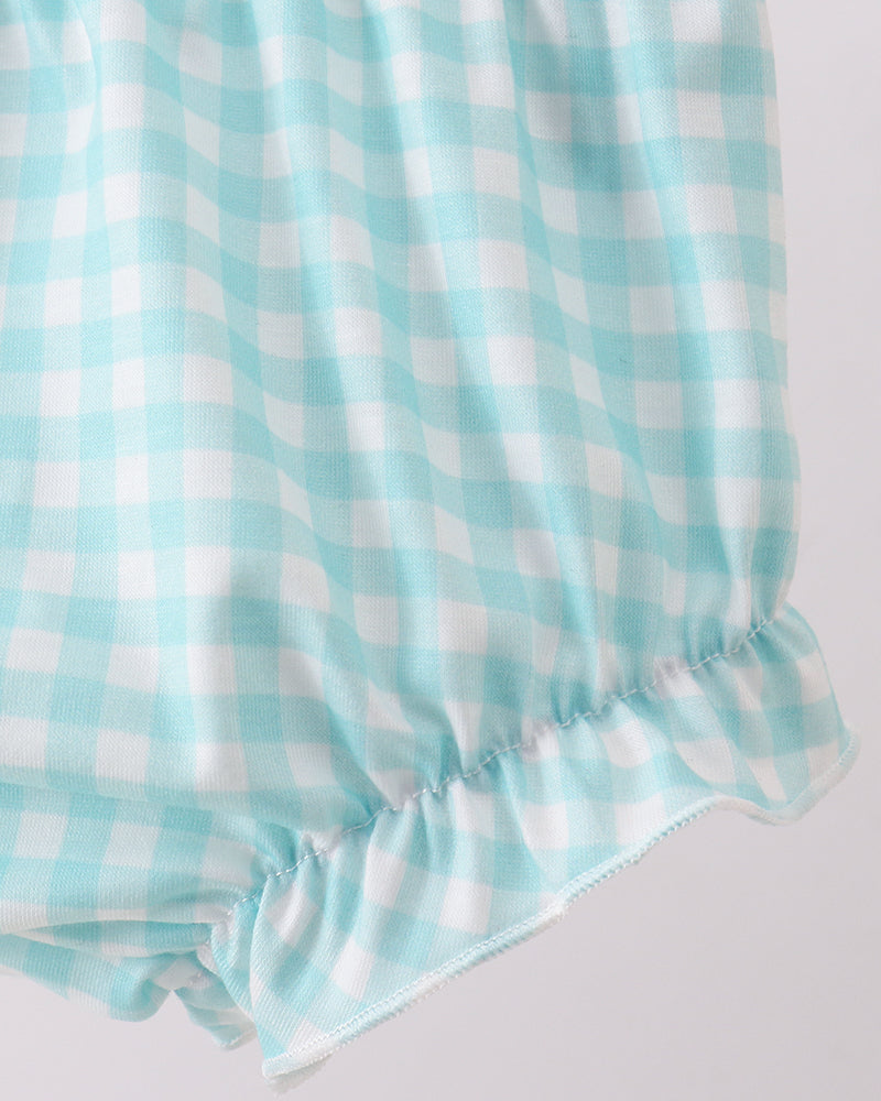 Light blue and white checkered fabric on a light gray background