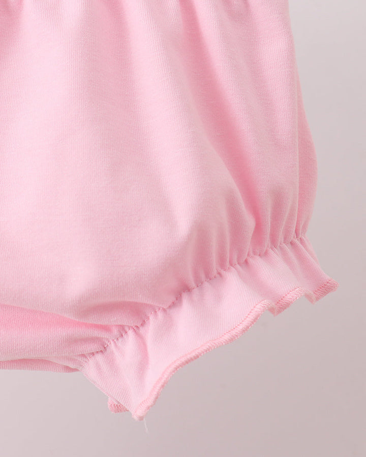 Pink baby bloomers on a light gray background