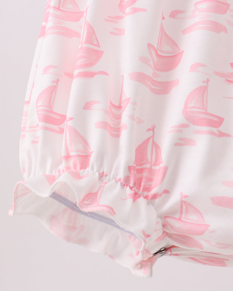 White fabric with pink sailboat pattern on a light gray background
