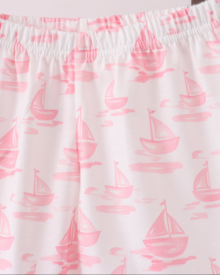 Shorts with pink sailboat pattern on a hanger