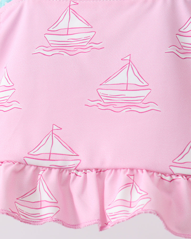 Pink fabric with sailboat pattern and ruffled edge