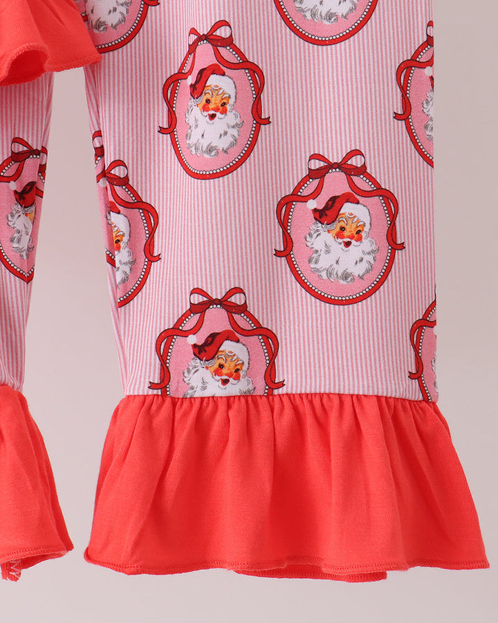 Pink pajama top with Santa face print and orange ruffle hem