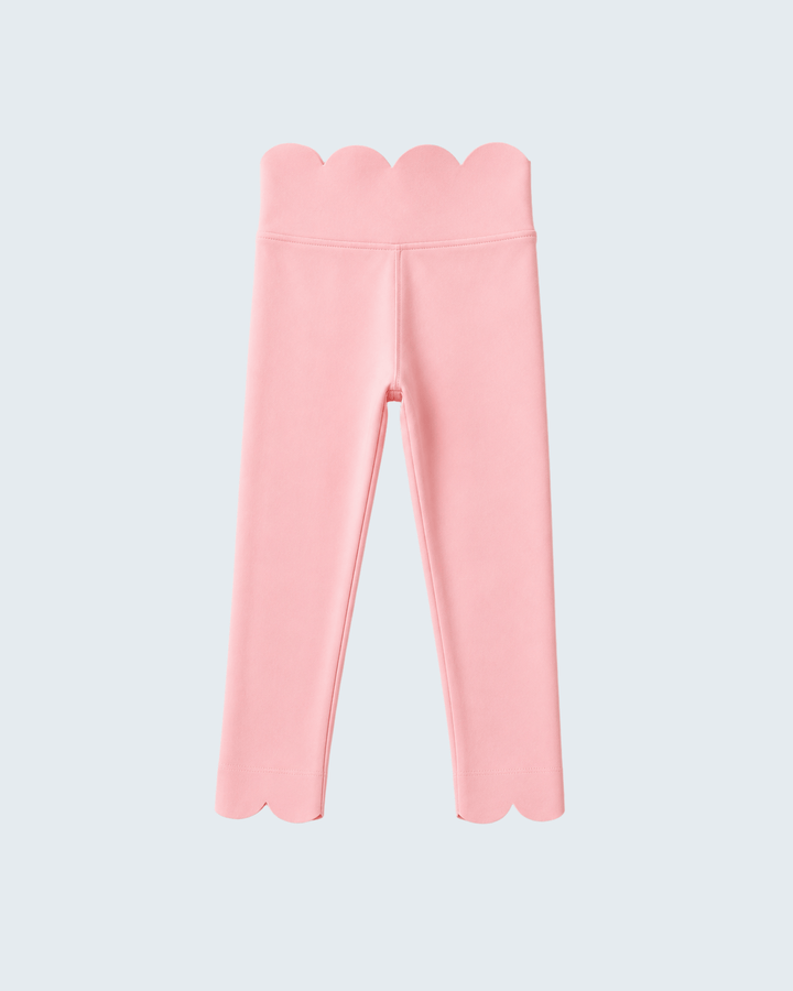 Pink leggings with scalloped edges on a light gray background