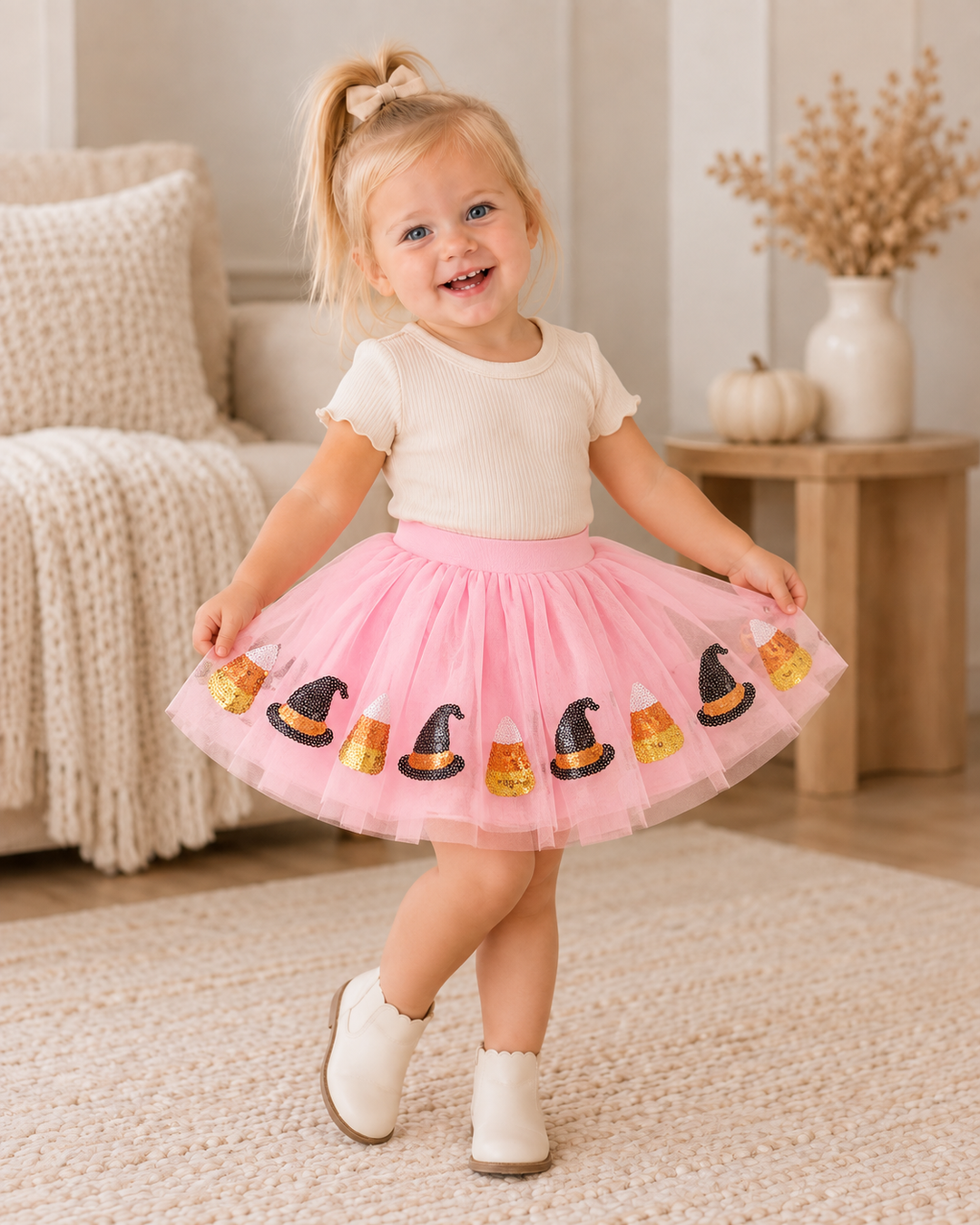 Pink tulle tutu skirt on child, with sequin witch hats and candy corn front print