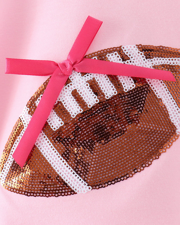 Sequin football patch with pink ribbon bow on pink bubble romper