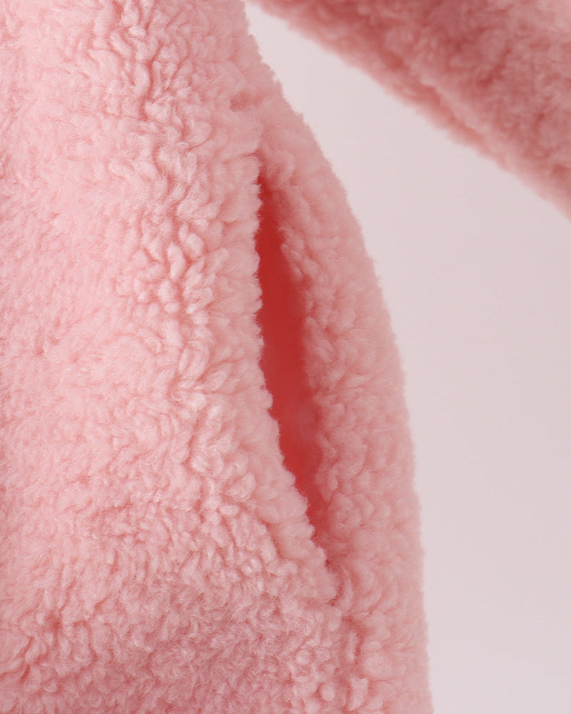 Pink fleece jacket sleeve with textured, curly pile fabric