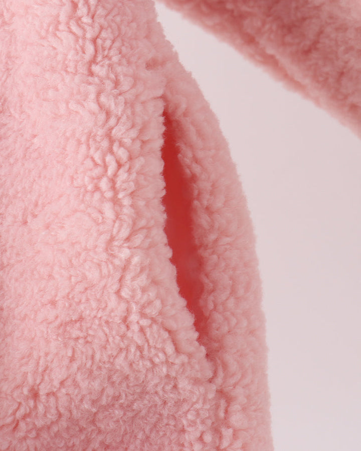Pink fleece jacket sleeve with textured, curly pile fabric
