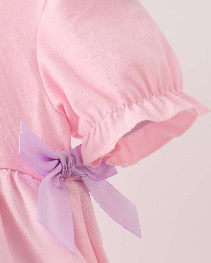 Pink puff sleeve with gathered shoulder and lilac ribbon tie detail