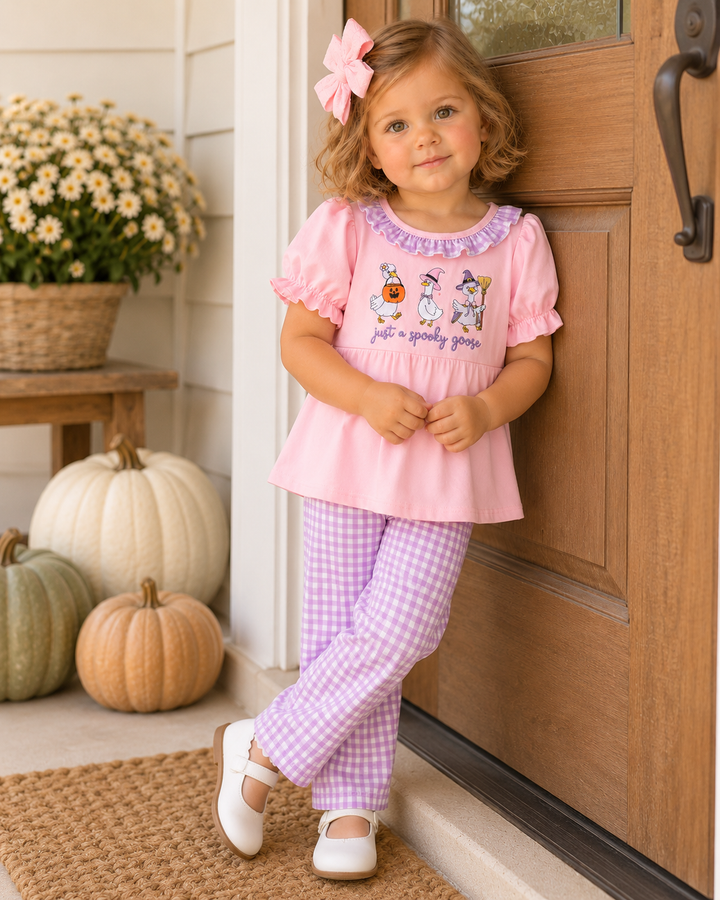 Pink embroidered ruffle-neck top with lavender gingham pants on a child