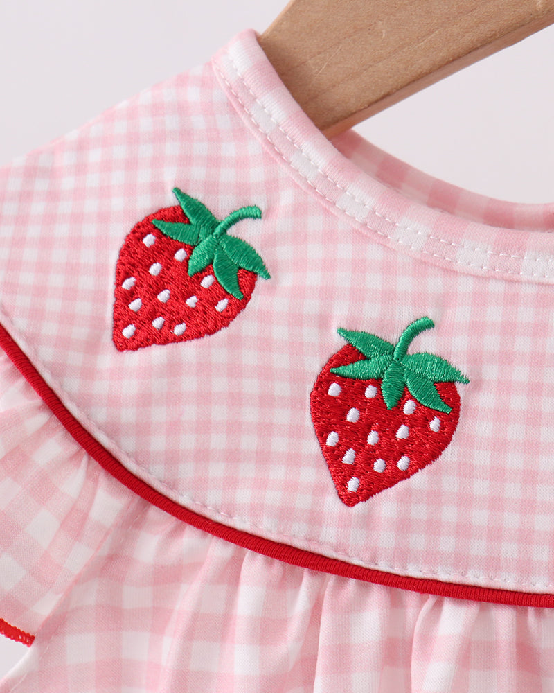 Close up of strawberry embroidery on romper