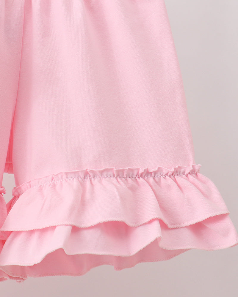 Pink baby top with layered ruffle hem and gathered elastic at waist