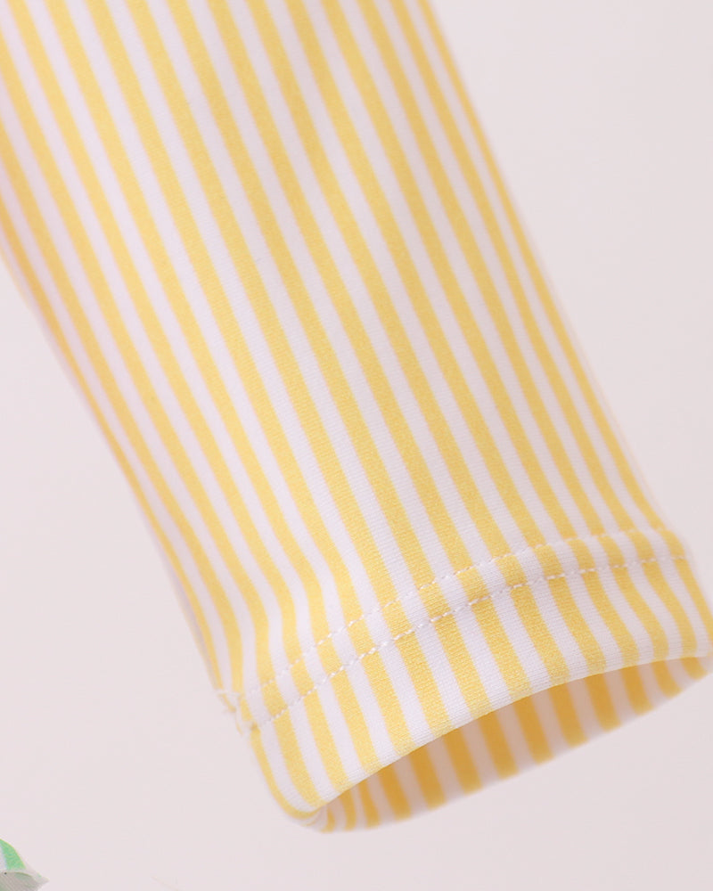 Close-up of a yellow and white striped fabric on a light background