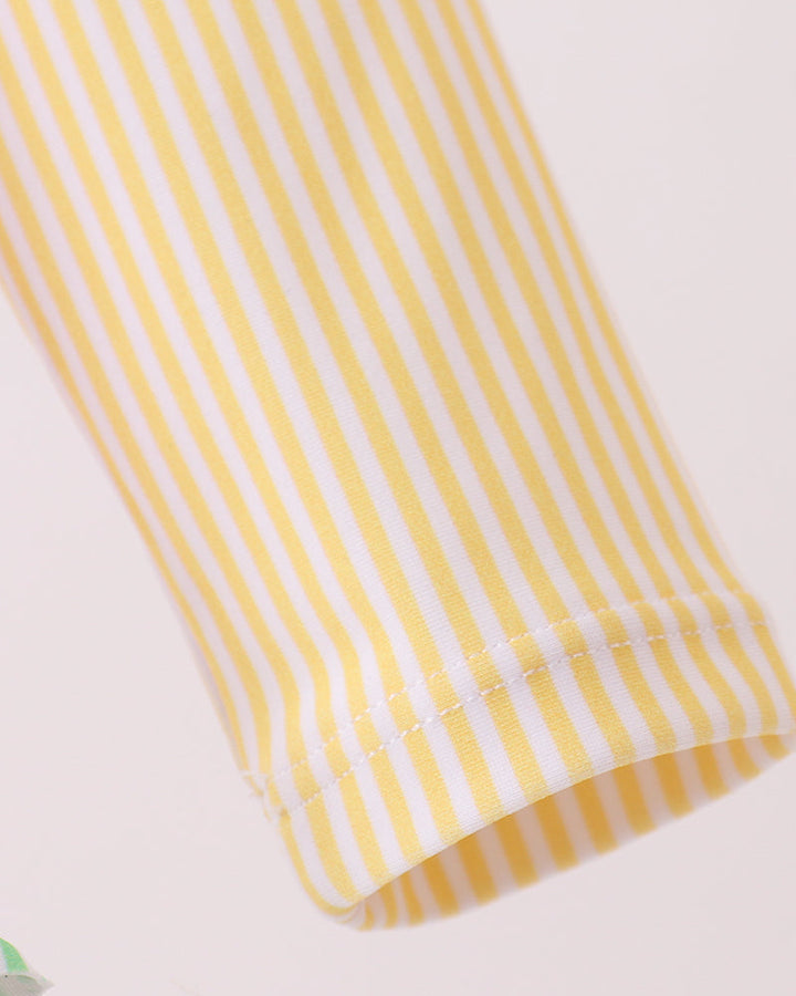 Close-up of a yellow and white striped fabric on a light background