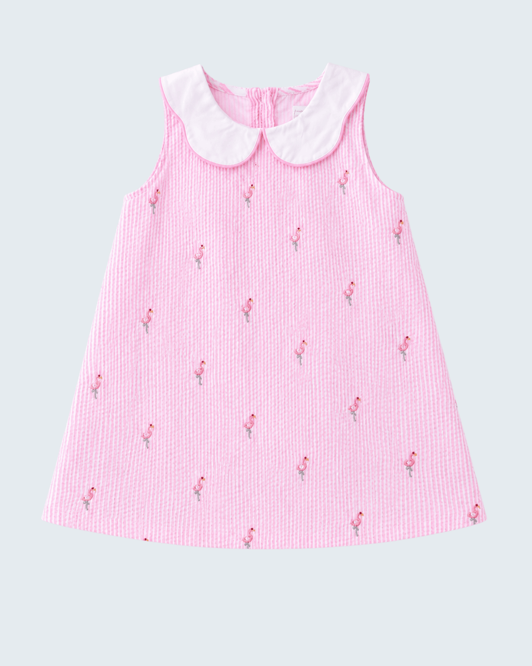 Pink dress with white collar on a light gray background