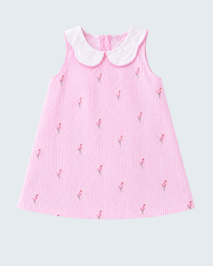 Pink dress with white collar on a light gray background