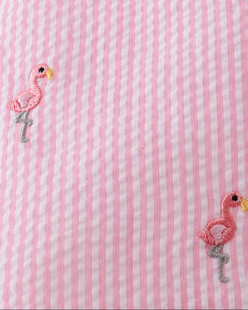 Pink and white striped fabric with embroidered flamingo designs.