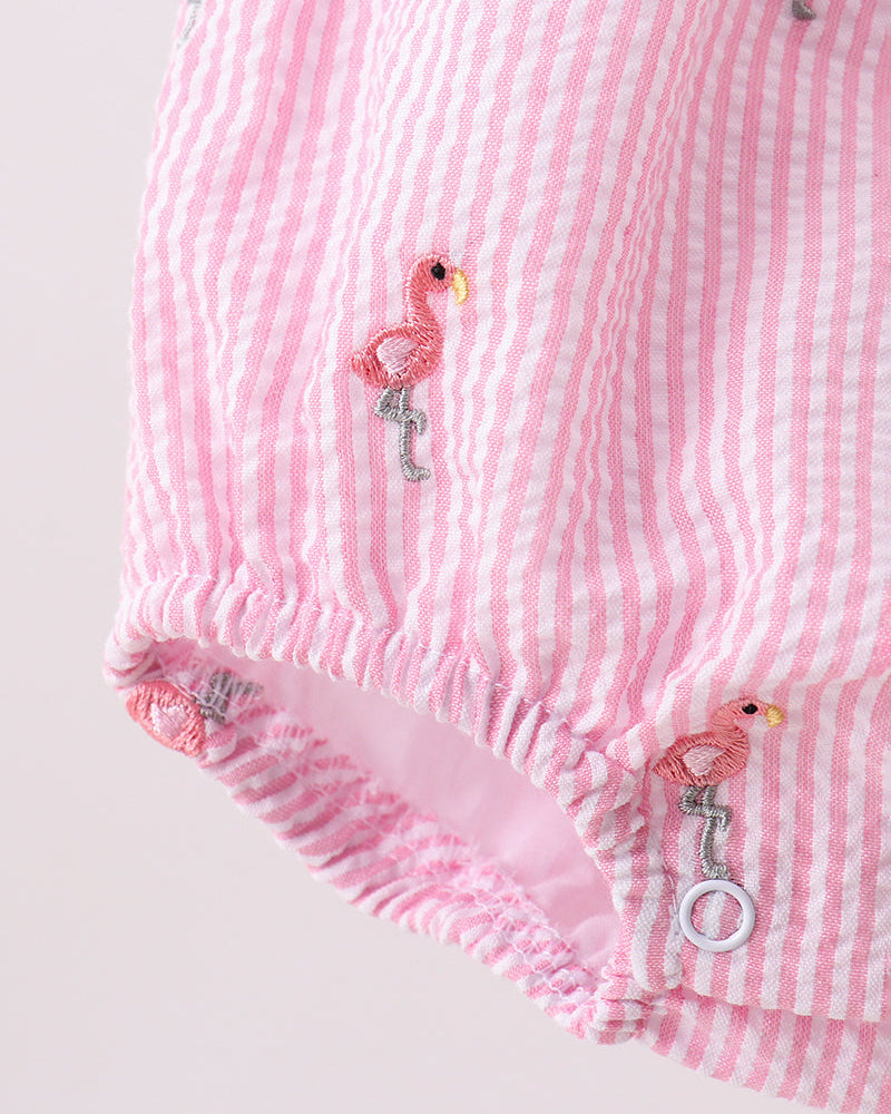 Pink striped baby bloomers with flamingo designs on a light gray background