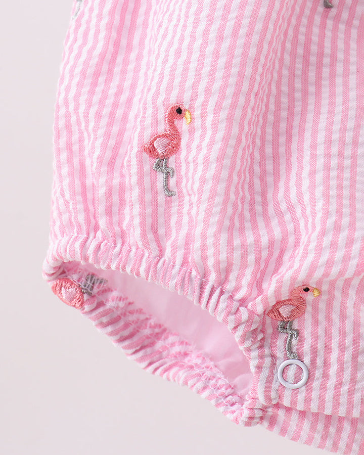 Pink striped baby bloomers with flamingo designs on a light gray background