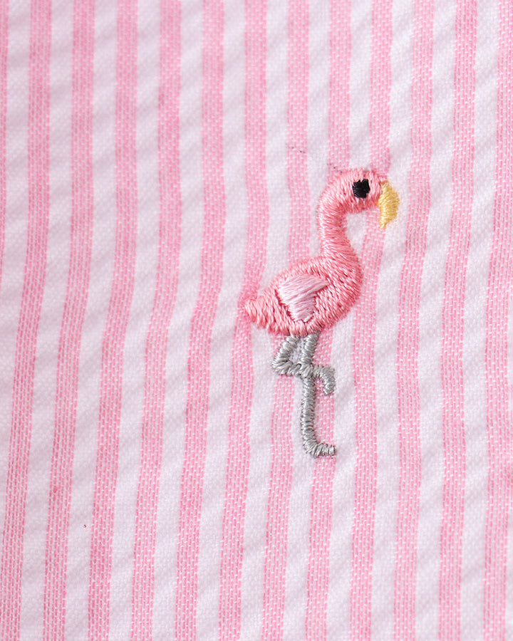 Pink and white striped fabric with an embroidered flamingo design.
