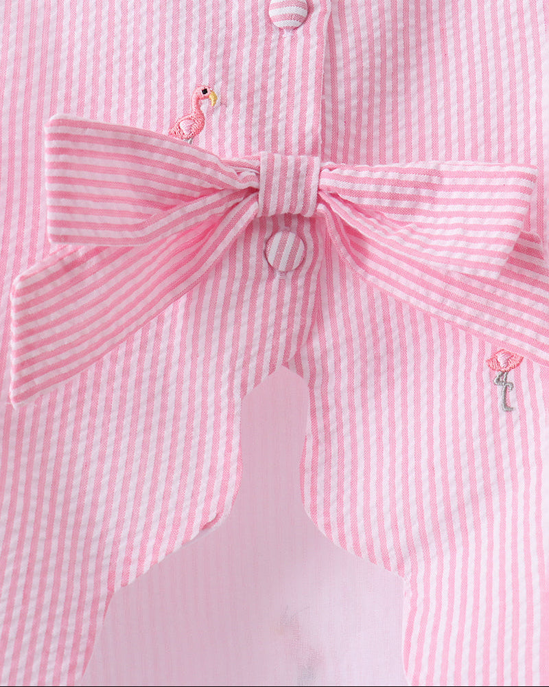 Pink and white striped shirt with a large bow detail on a mannequin.
