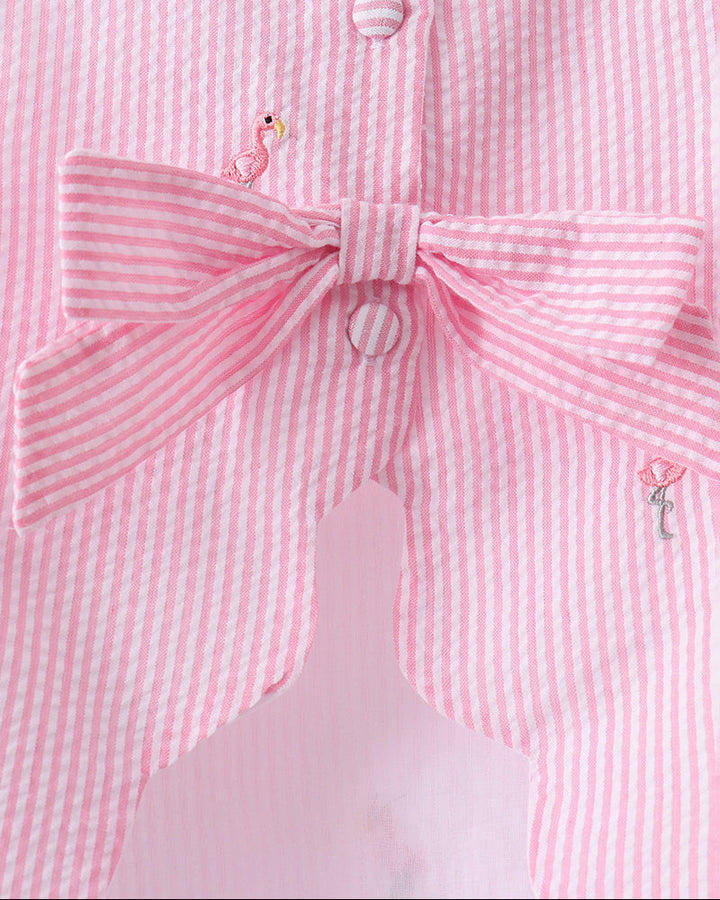 Pink and white striped shirt with a large bow detail on a mannequin.