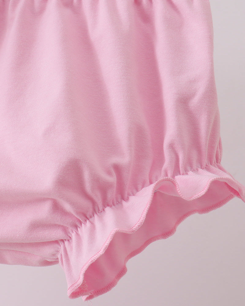 Pink baby bloomers on a light gray background