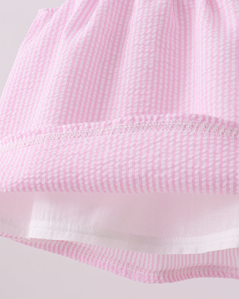 Close-up of a pink textured fabric with a white background