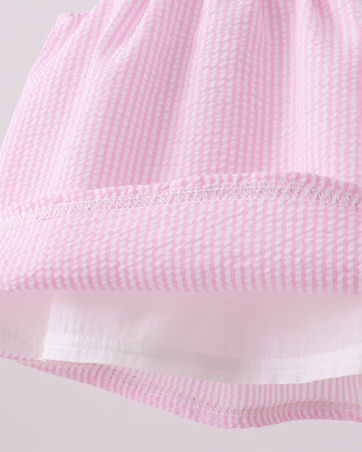 Close-up of a pink textured fabric with a white background