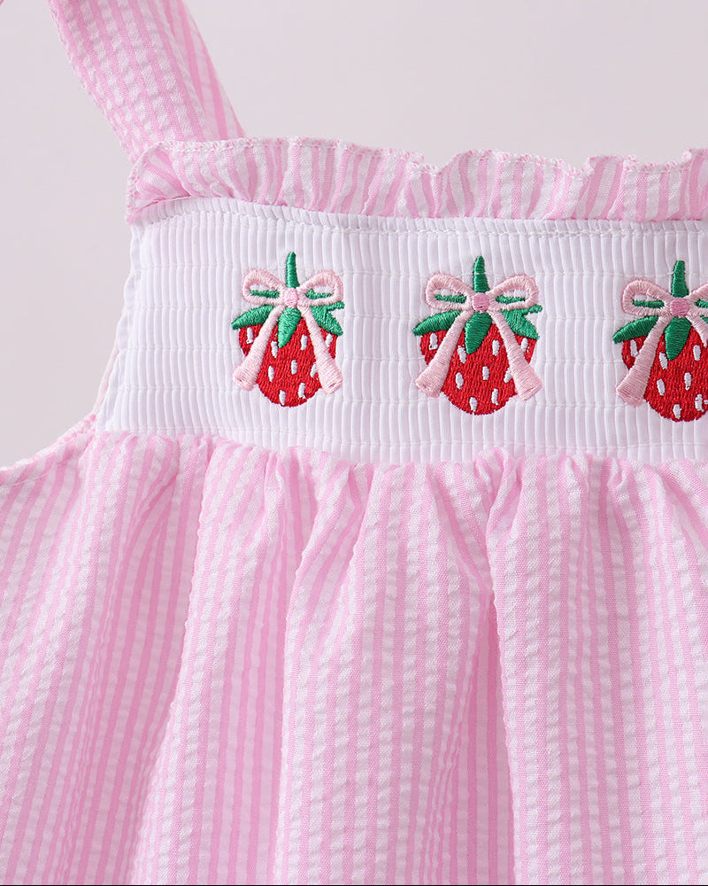 Pink dress with strawberry embroidery on a white background
