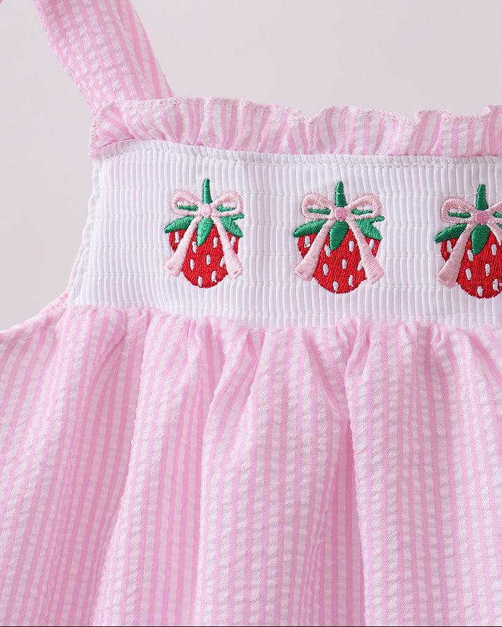 Pink dress with strawberry embroidery on a white background