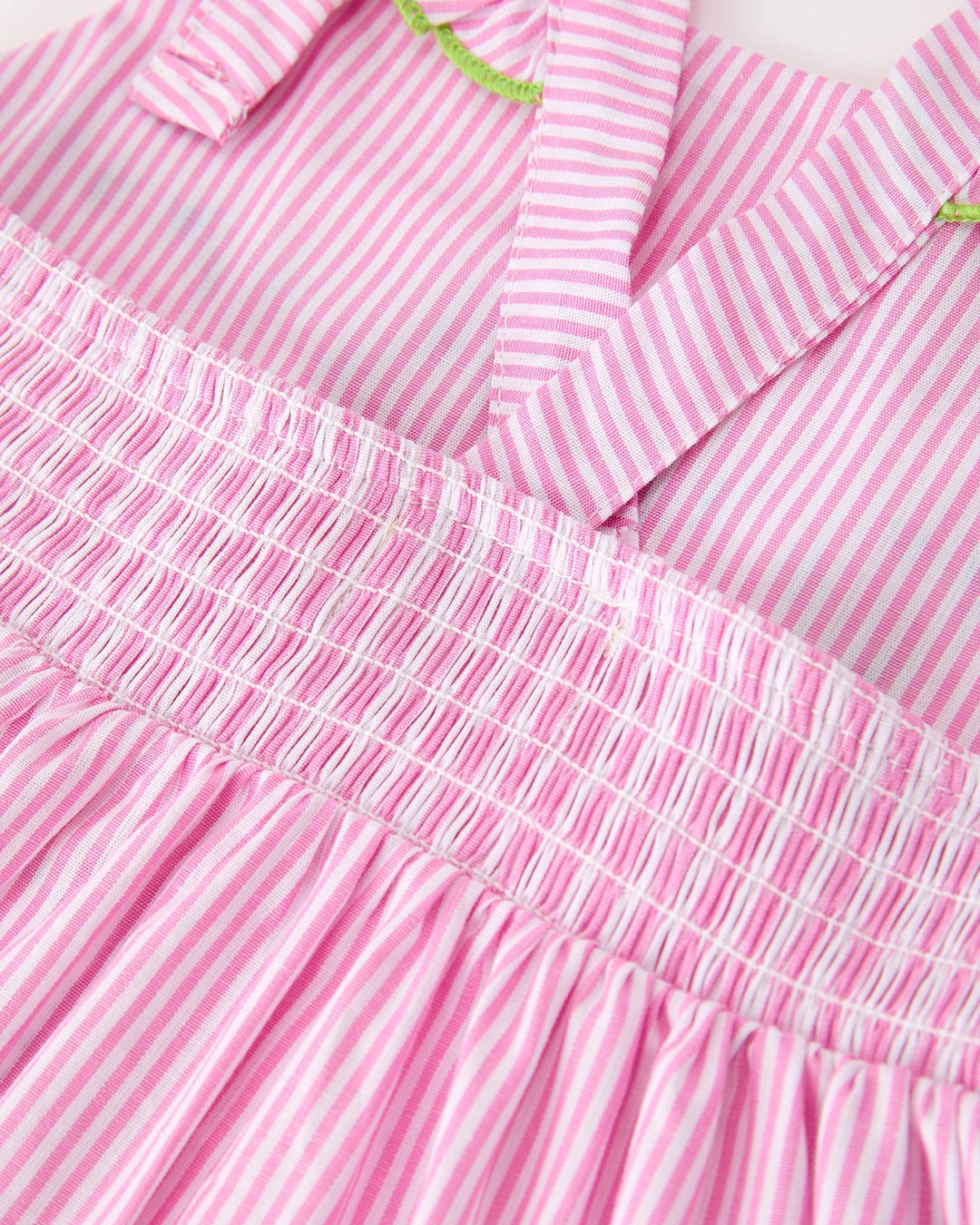 Close-up of a pink and white striped dress with smocked waistband