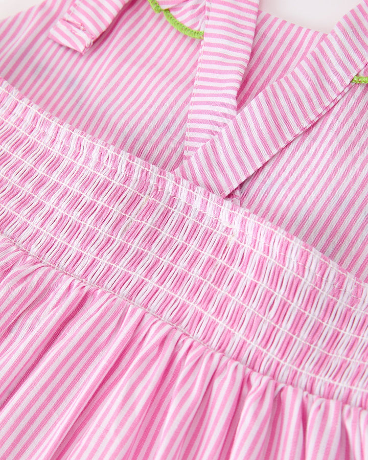 Close-up of a pink and white striped dress with smocked waistband