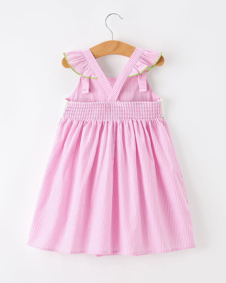 Pink striped dress with ruffled collar on a wooden hanger against a white background