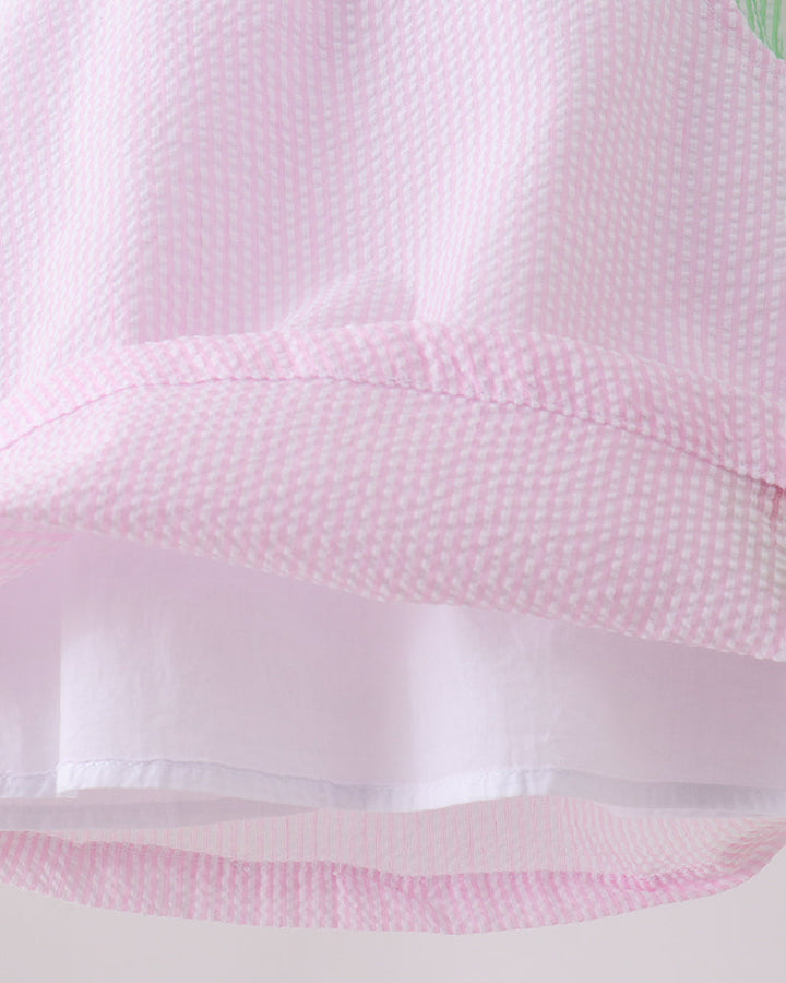 Close-up of pink textured fabric with a white border