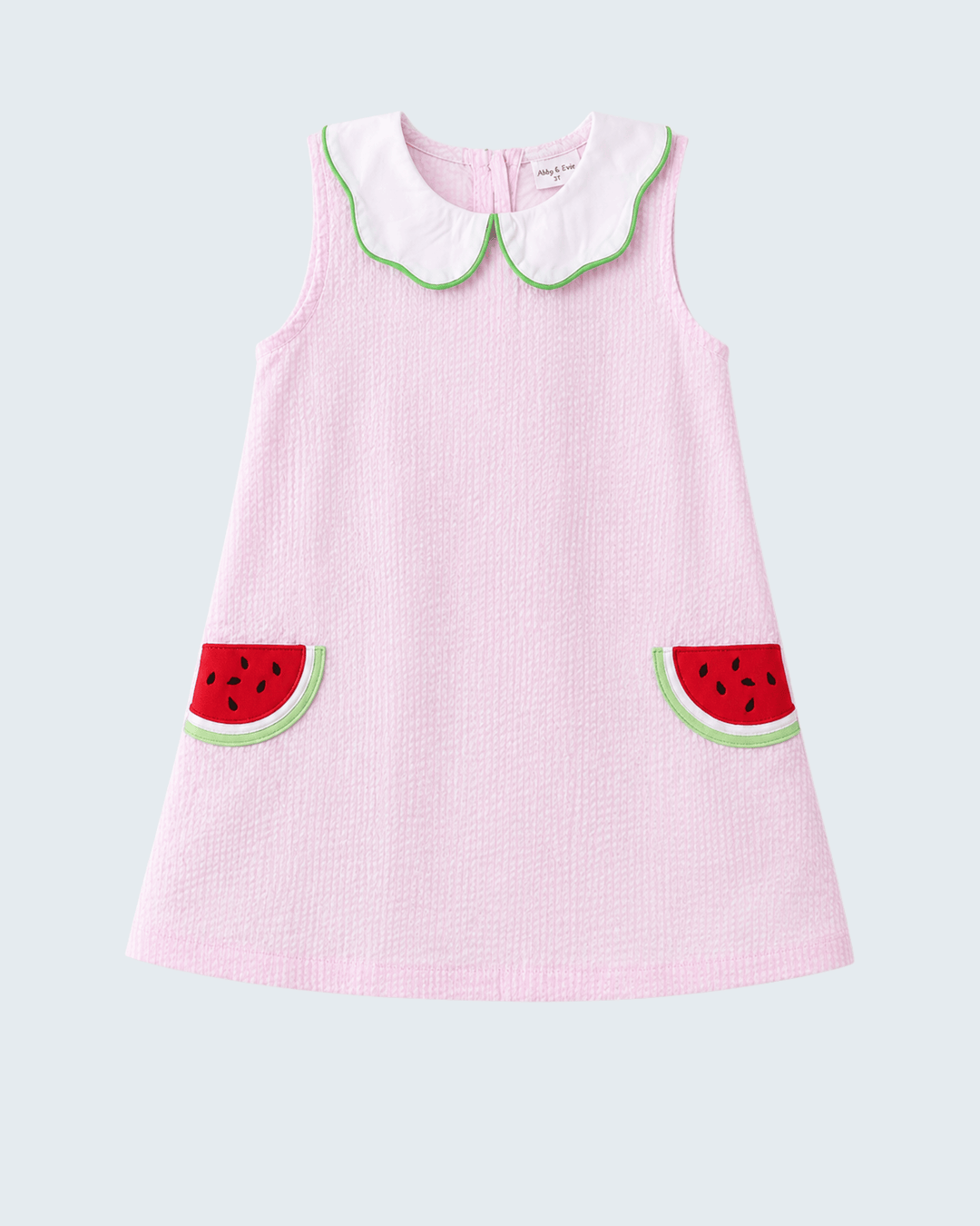Pink dress with watermelon design on a light gray background
