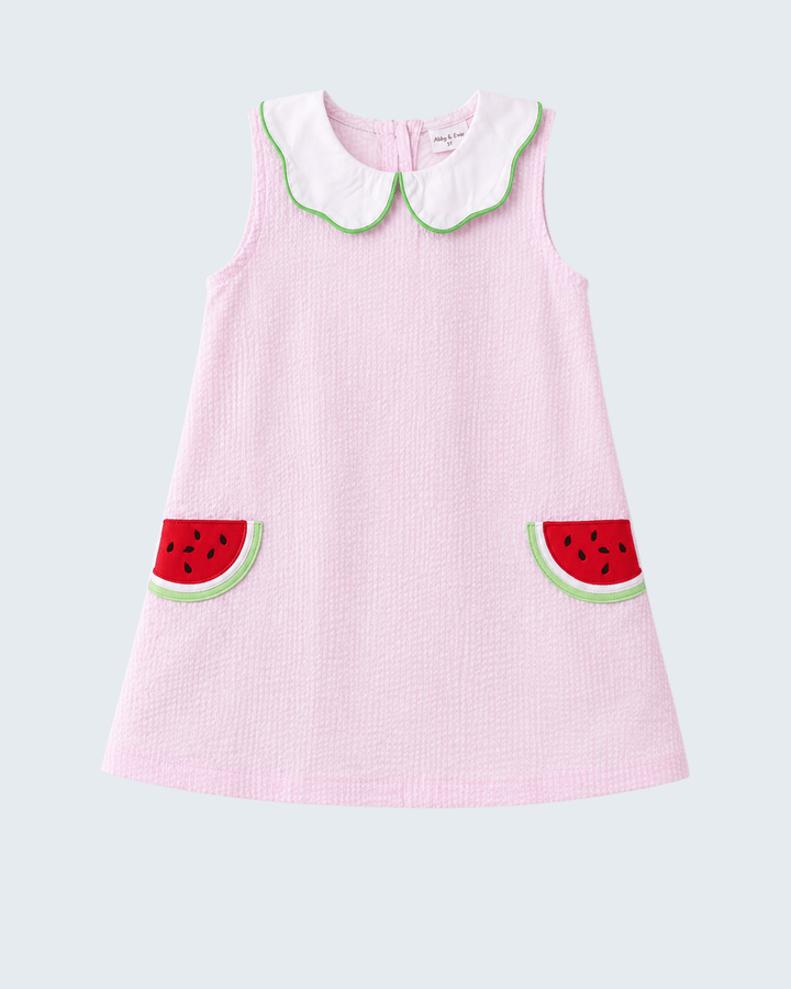 Pink dress with watermelon design on a light gray background