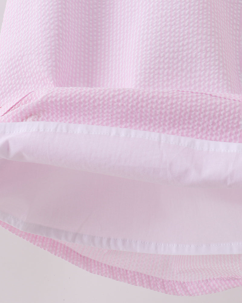 Close-up of pink fabric with a textured pattern