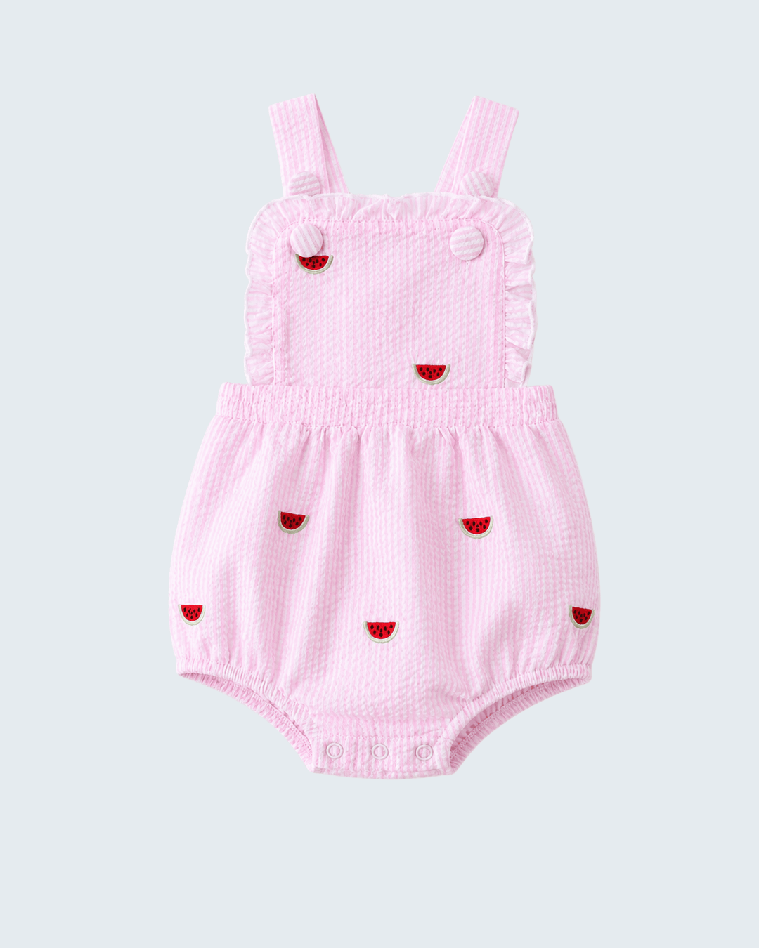 Pink baby romper with red heart designs on a light gray background